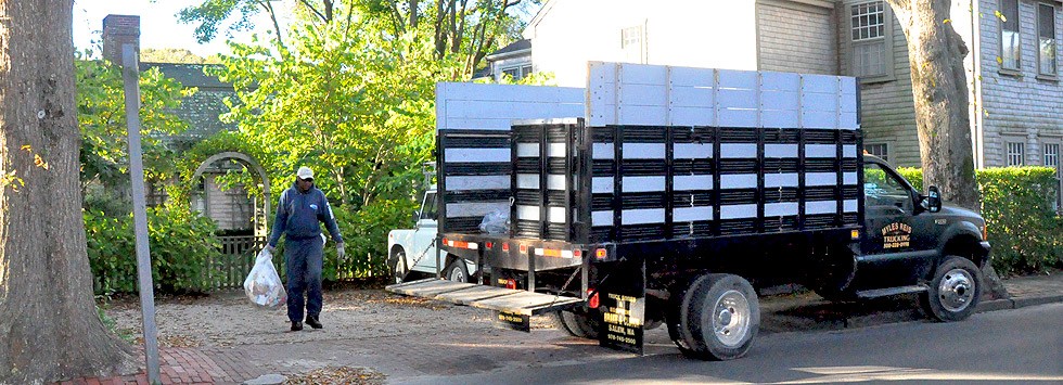Island Rubbish crew making a residential pickup on a Nantucket street